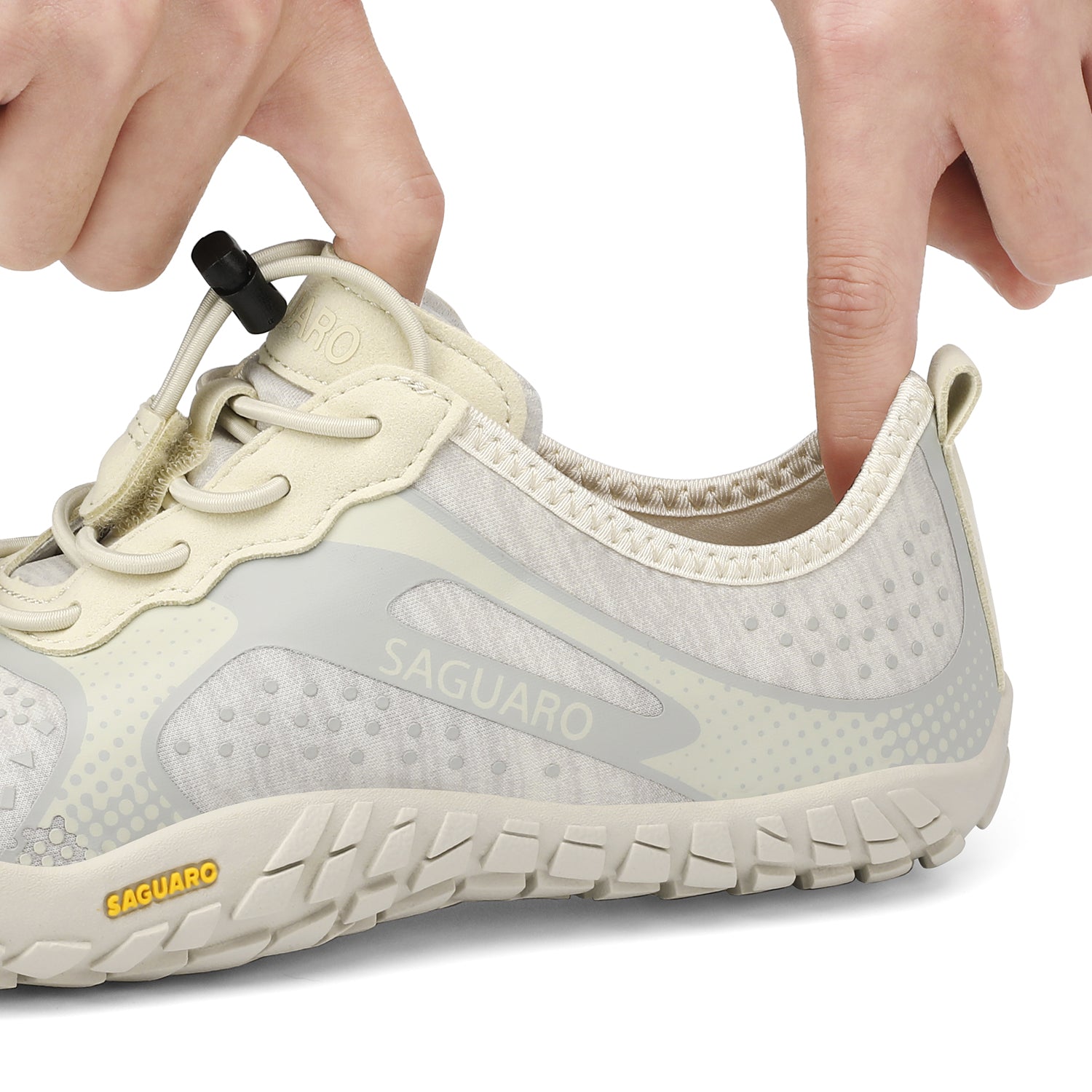 Saguaro shoe being adjusted with a hand on a white background